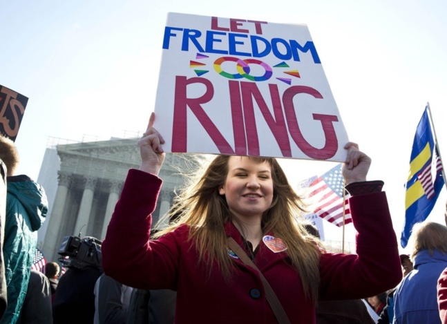 A supporter of gay marriage holds a sign in front of the Supreme Court in Washington March 27, 2013. (Joshua Roberts/Reuters)